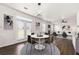Open-concept dining room with modern lighting, art and access to the outdoor space for seamless indoor-outdoor living at 3524 Preserve Run Trl, Loganville, GA 30052