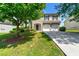 Inviting two-story home with brick accents, attached garage, and tree in the yard at 3524 Preserve Run Trl, Loganville, GA 30052