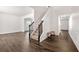Bright foyer with hardwood floors, staircase, and white trim, leading to adjacent rooms at 3524 Preserve Run Trl, Loganville, GA 30052