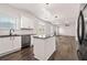Stylish kitchen featuring white cabinets, stainless steel appliances, granite countertops, and an island with backyard views at 3524 Preserve Run Trl, Loganville, GA 30052
