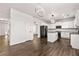 Bright open kitchen featuring white cabinets, black appliances, granite countertops and an island with an open layout at 3524 Preserve Run Trl, Loganville, GA 30052