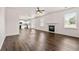 Spacious living room with fireplace, hardwood floors, and an open-concept design to the kitchen and dining area at 3524 Preserve Run Trl, Loganville, GA 30052