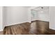 Open-concept living room with hardwood floors, white walls, and ample natural light at 3524 Preserve Run Trl, Loganville, GA 30052