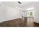 Bright living room with hardwood floors, modern lighting, and wainscoting, creating an inviting and elegant space at 3524 Preserve Run Trl, Loganville, GA 30052