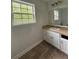 Bathroom features a white vanity, a large mirror, and tiled flooring at 4069 Savannah Ridge Ct, Loganville, GA 30052