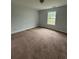 Bedroom featuring a window and carpet floors at 4069 Savannah Ridge Ct, Loganville, GA 30052