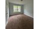 Bedroom featuring a window and carpet floors at 4069 Savannah Ridge Ct, Loganville, GA 30052