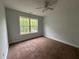 Bright bedroom features neutral carpet and large windows for ample natural light at 4069 Savannah Ridge Ct, Loganville, GA 30052