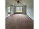 Bedroom featuring a ceiling fan, carpeted floor, and double window at 4069 Savannah Ridge Ct, Loganville, GA 30052