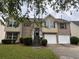Inviting two-story home with brick accents, a two-car garage, and a landscaped front yard at 4069 Savannah Ridge Ct, Loganville, GA 30052