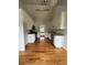 Well-lit kitchen features white cabinetry, hardwood flooring, and stainless steel appliances at 4069 Savannah Ridge Ct, Loganville, GA 30052