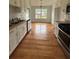 Functional kitchen with white cabinets, stainless steel appliances, and a view into the dining area at 4069 Savannah Ridge Ct, Loganville, GA 30052