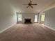 Spacious living room boasts a brick fireplace, neutral carpet, and plenty of natural light at 4069 Savannah Ridge Ct, Loganville, GA 30052