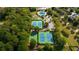 Aerial view showcasing tennis courts, pool, and lush landscaping within the community at 626 Dahoma Trail Trl, Woodstock, GA 30188