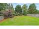 Spacious backyard featuring a well manicured lawn, privacy fence and mature shade trees at 626 Dahoma Trail Trl, Woodstock, GA 30188