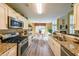Well-equipped kitchen with stainless steel appliances and granite countertops at 626 Dahoma Trail Trl, Woodstock, GA 30188