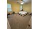 Bedroom features light-yellow walls, carpet flooring, two windows, and a ceiling fan with light at 6550 Wellington Chase Ct, Lithonia, GA 30058