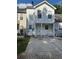 Two-story home features white siding, porch with white railings, and a concrete driveway on a partly cloudy day at 6550 Wellington Chase Ct, Lithonia, GA 30058