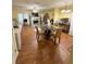 Open floor plan features wood floors, fireplace, white mantel, TV, dining table, and desk at 6550 Wellington Chase Ct, Lithonia, GA 30058