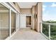 Outdoor balcony featuring tile flooring, glass railings, and views of the cityscape and trees at 2881 Peachtree Ne Rd # 1202, Atlanta, GA 30305