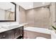 Modern bathroom boasts an elegant vanity, bathtub with shower, and sleek tiled walls at 2881 Peachtree Ne Rd # 1202, Atlanta, GA 30305