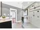 Luxury bathroom featuring a glass shower, modern vanity, shower heads and light gray tile flooring at 2881 Peachtree Ne Rd # 1202, Atlanta, GA 30305