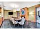 Formal dining room with a fireplace, large table, black tile floors and a tv at 2881 Peachtree Ne Rd # 1202, Atlanta, GA 30305