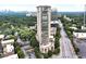 Stunning aerial view of a modern high-rise building in a bustling city, surrounded by lush greenery at 2881 Peachtree Ne Rd # 1202, Atlanta, GA 30305