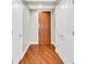 Inviting hallway featuring hardwood floors, white trim and doors, and neutral wall paint at 2881 Peachtree Ne Rd # 1202, Atlanta, GA 30305