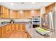 Bright kitchen featuring stainless steel appliances, granite countertops, wooden cabinets, and hardwood floors at 2881 Peachtree Ne Rd # 1202, Atlanta, GA 30305