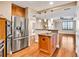 Open kitchen and living area with stainless steel appliances, island, and hardwood floors at 2881 Peachtree Ne Rd # 1202, Atlanta, GA 30305