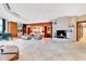 A spacious living room features a fireplace, piano, travertine floors, and stylish furnishings at 2881 Peachtree Ne Rd # 1202, Atlanta, GA 30305