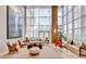 Two story lobby area with floor to ceiling windows and a seating area at 2881 Peachtree Ne Rd # 1202, Atlanta, GA 30305