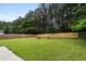 A sprawling, fenced backyard with lush green grass, bordered by mature trees, offering privacy at 3915 Cypress Pointe Dr, Union City, GA 30291