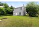 A well maintained backyard featuring a lush lawn and the rear facade of a two-story home at 3915 Cypress Pointe Dr, Union City, GA 30291