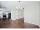 Open dining area with modern chandelier, hardwood floors, and kitchen access at 3915 Cypress Pointe Dr, Union City, GA 30291