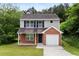 Charming two-story home with brick and vinyl siding and attached one car garage at 3915 Cypress Pointe Dr, Union City, GA 30291