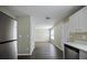 Open kitchen and dining area with stainless steel appliances and dark wood floors at 3915 Cypress Pointe Dr, Union City, GA 30291