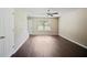 Spacious living room with hardwood floors, a ceiling fan, and a door to the outside at 3915 Cypress Pointe Dr, Union City, GA 30291