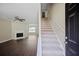 Spacious living room with hardwood floors, fireplace, ceiling fan and staircase at 3915 Cypress Pointe Dr, Union City, GA 30291