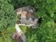 Aerial view of a home nestled amongst mature trees and lush landscaping at 405 Forest Valley Road, Sandy Springs, GA 30342