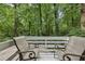 Relaxing outdoor deck showcasing seating and a beautiful wooded view at 405 Forest Valley Road, Sandy Springs, GA 30342
