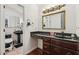 Elegant bathroom boasts dark wood cabinets, a black marble counter, and a decorative mirror at 405 Forest Valley Road, Sandy Springs, GA 30342