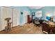 Bright blue bedroom with hardwood floors, two closets, a globe, and a desk by a window at 405 Forest Valley Road, Sandy Springs, GA 30342