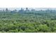 Distant city skyline view with lush, green forest in the foreground at 405 Forest Valley Road, Sandy Springs, GA 30342