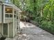 Scenic view of the home's exterior with mature trees, long driveway, and a charming architectural design at 405 Forest Valley Road, Sandy Springs, GA 30342
