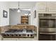 Well-appointed kitchen featuring a stainless steel oven and gas cooktop at 405 Forest Valley Road, Sandy Springs, GA 30342