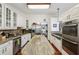 Spacious kitchen featuring granite countertops, stainless steel appliances, and hardwood floors at 405 Forest Valley Road, Sandy Springs, GA 30342