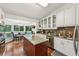 Open-concept kitchen with granite counters, white cabinets, stainless appliances, and an island at 405 Forest Valley Road, Sandy Springs, GA 30342