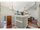 Spacious living area features hardwood floors, neutral colors, chandelier and staircase to lower level at 405 Forest Valley Road, Sandy Springs, GA 30342